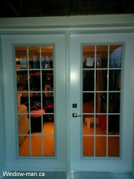 Exterior French doors. Inswing patio doors installation. Full glass. White grills. 15 Lite Glass. Installed